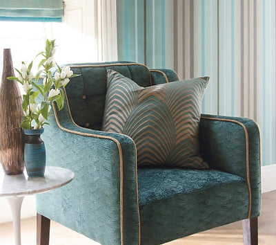 Shot of a cozy armchair with a cushion and vases on side table in modern living room Cushion Reupholstery